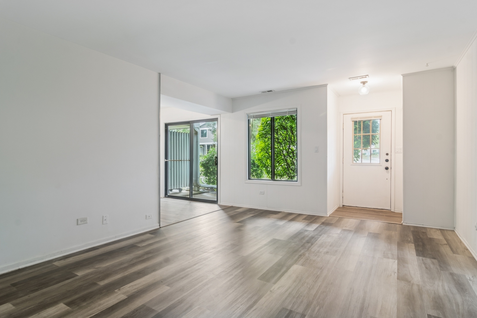 452 Harrison Court Vernon Hills, IL 60061 - Photo 2 of 11 an empty room with wooden floor and windows
