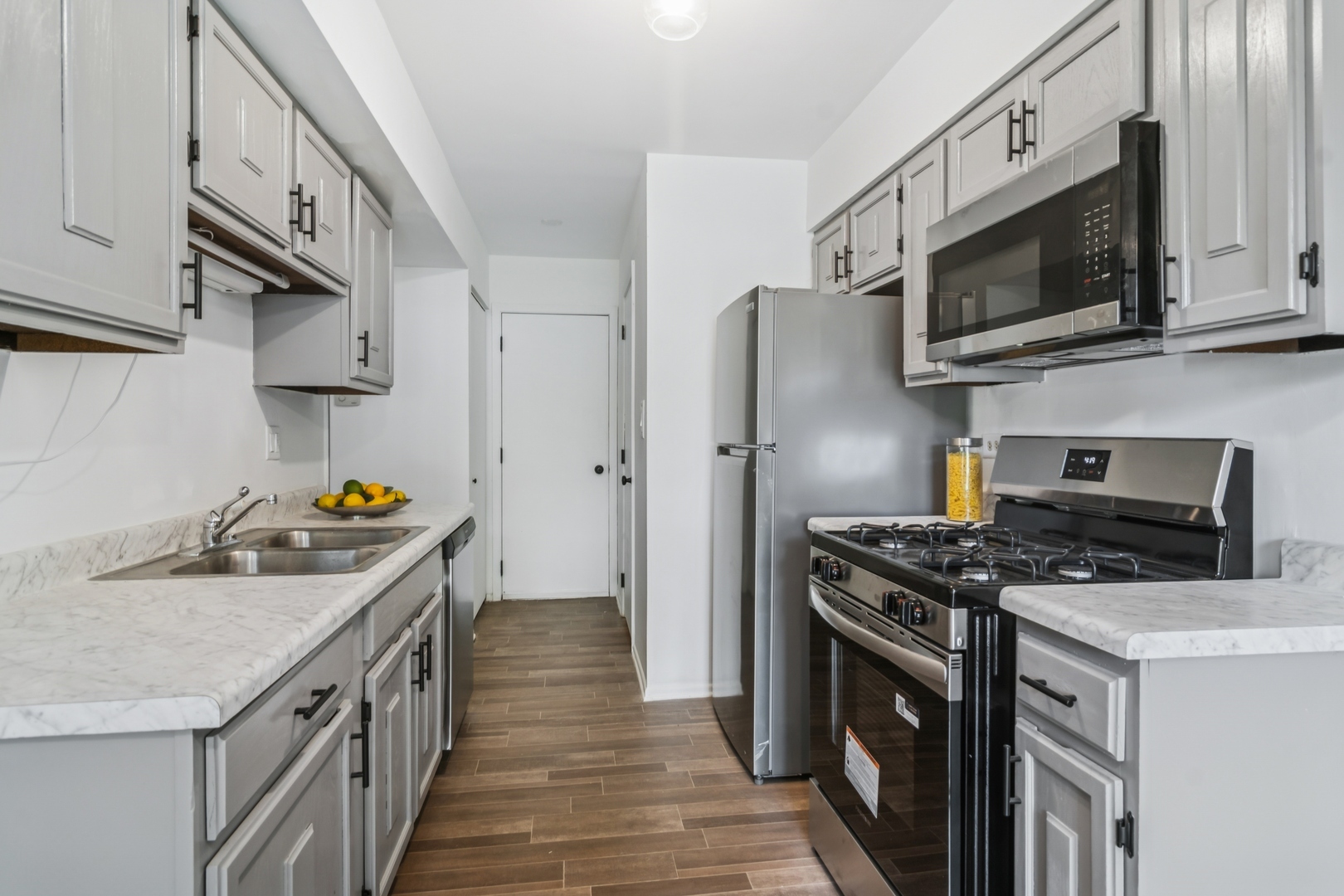452 Harrison Court Vernon Hills, IL 60061 - Photo 4 of 11 a kitchen with stainless steel appliances a stove a sink and a microwave