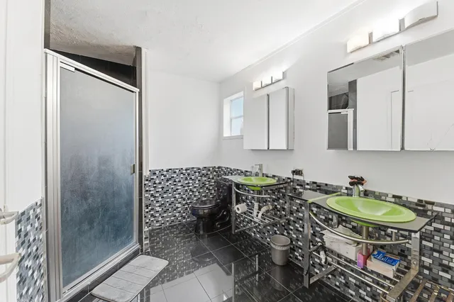 a bathroom with a sink toilet and shower