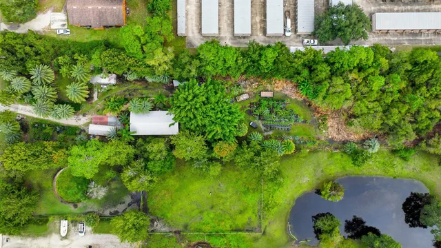 an aerial view of a house with a yard and lake view