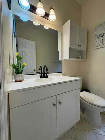 a bathroom with a sink toilet and mirror
