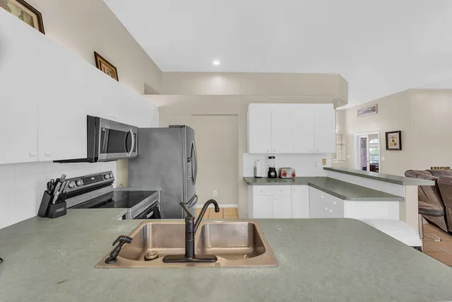 a kitchen with furniture and a flat screen tv