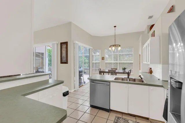 a very nice looking room with a large window and chandelier