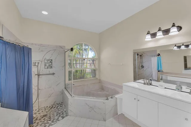 a bathroom with a double vanity sink and a mirror