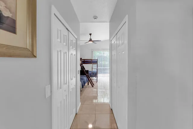 a bed room with a bed and a ceiling fan