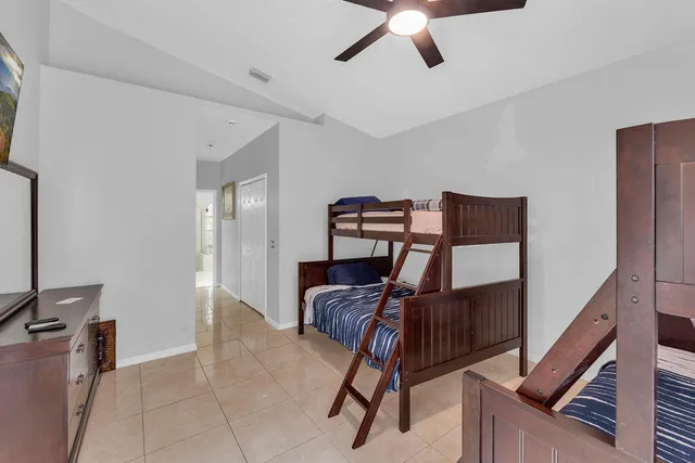 a living room with furniture and a ceiling fan