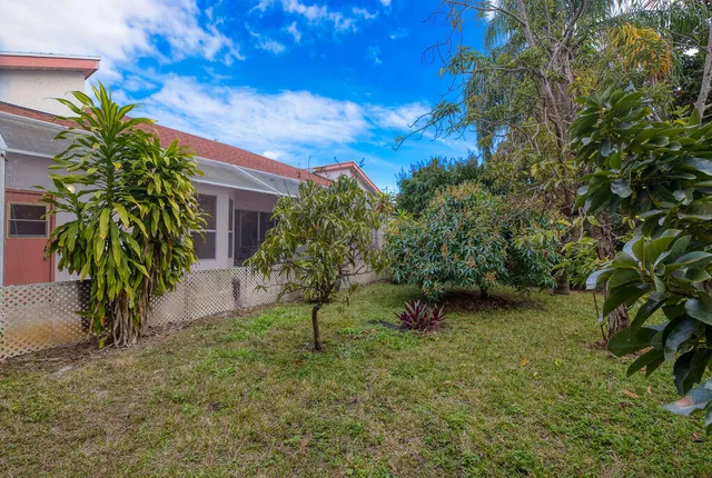 a view of a wooden house with a tree