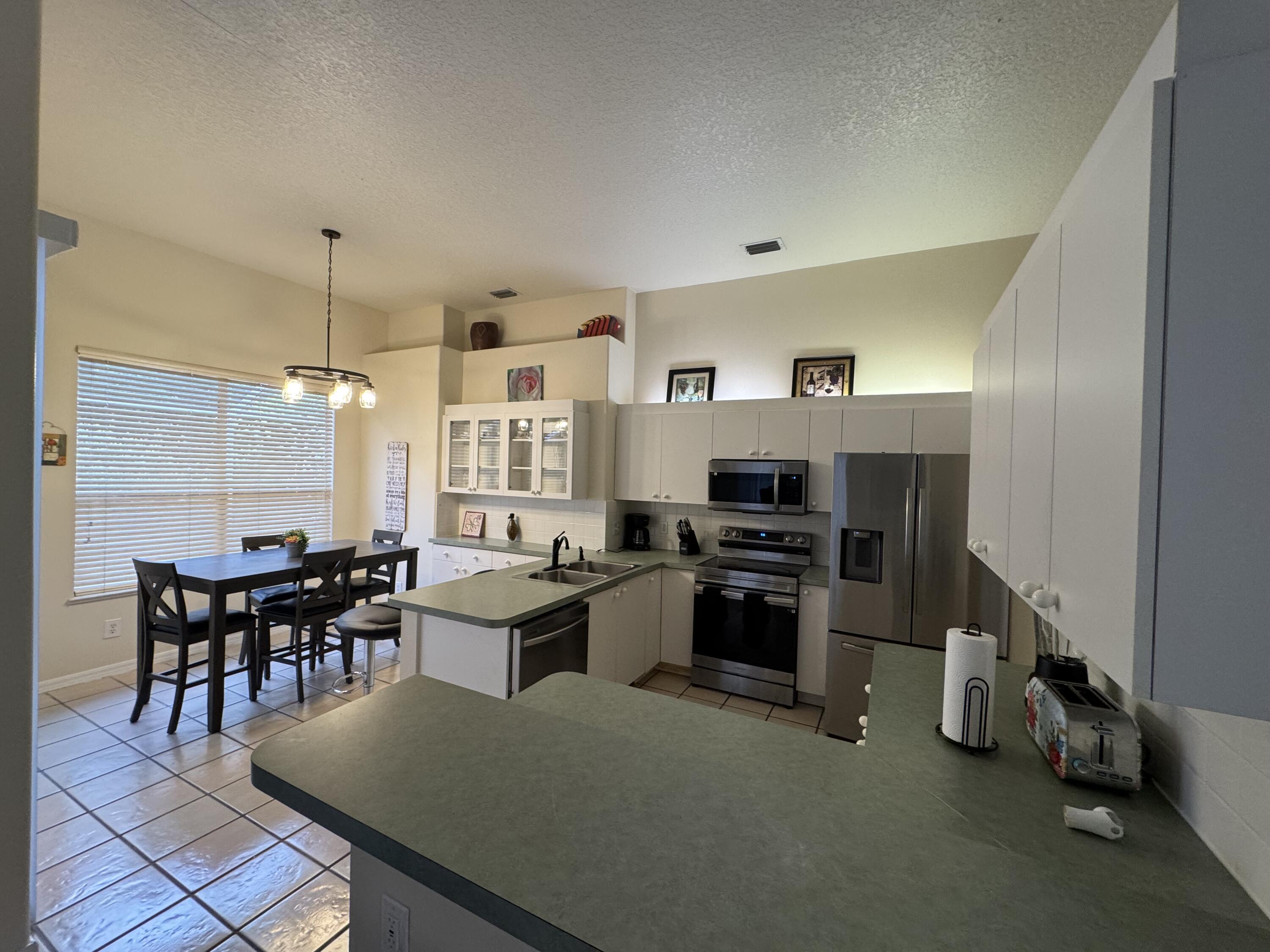 1872 Southwest Airoso Boulevard Port St. Lucie, FL 34984 - Photo 6 of 12 a view of a dining room with furniture