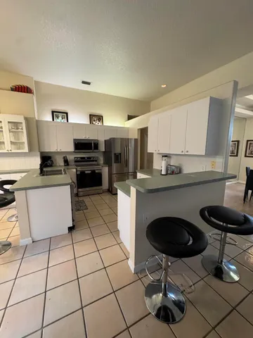 a view of a dining room with furniture and chandelier