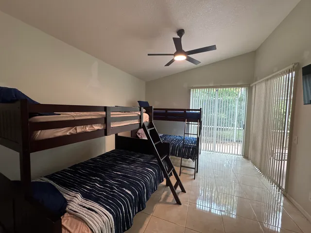 a bedroom with a bed and a lamp