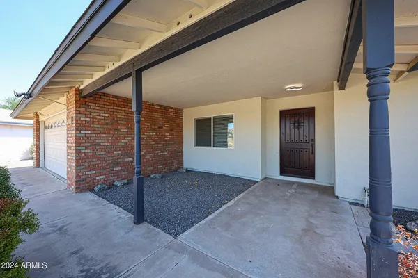 a view of a house with an empty space and wooden deck