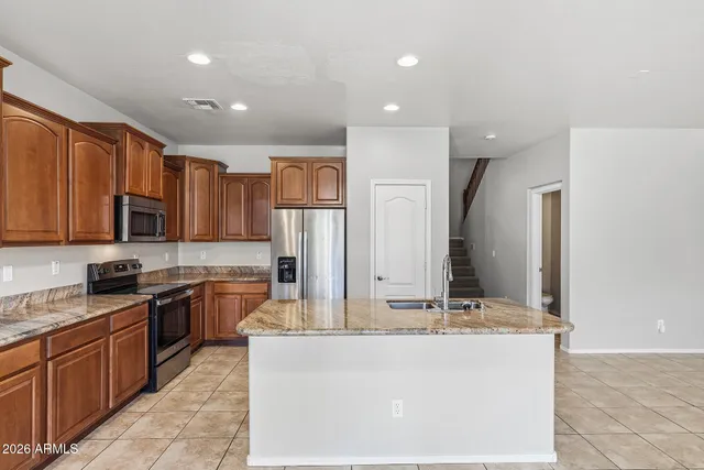 a kitchen with stainless steel appliances granite countertop a sink and cabinets