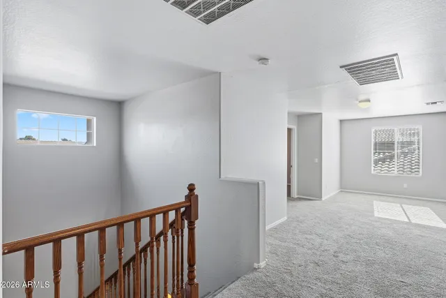 a view of entryway with wooden floor and stairs