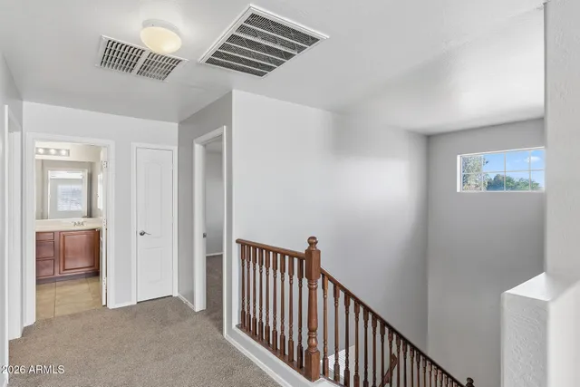 a view of hallway with window and stairs