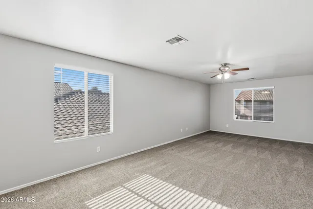 a view of a big room with chandelier fan and closet area