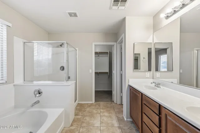 an empty room and chandelier fan