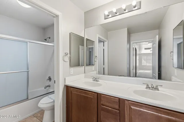 a bathroom with a sink double vanity and a mirror