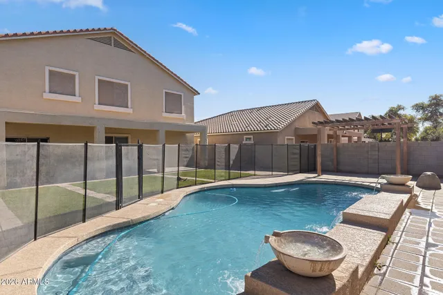 a swimming pool with outdoor seating and yard