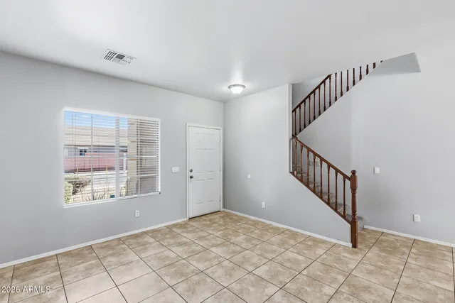 a view of a kitchen with stainless steel appliances a refrigerator and a stove top oven