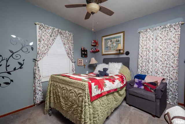 a bedroom with bed and a chandelier