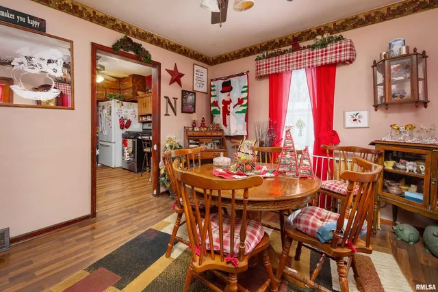 a dining room with furniture and wooden floor