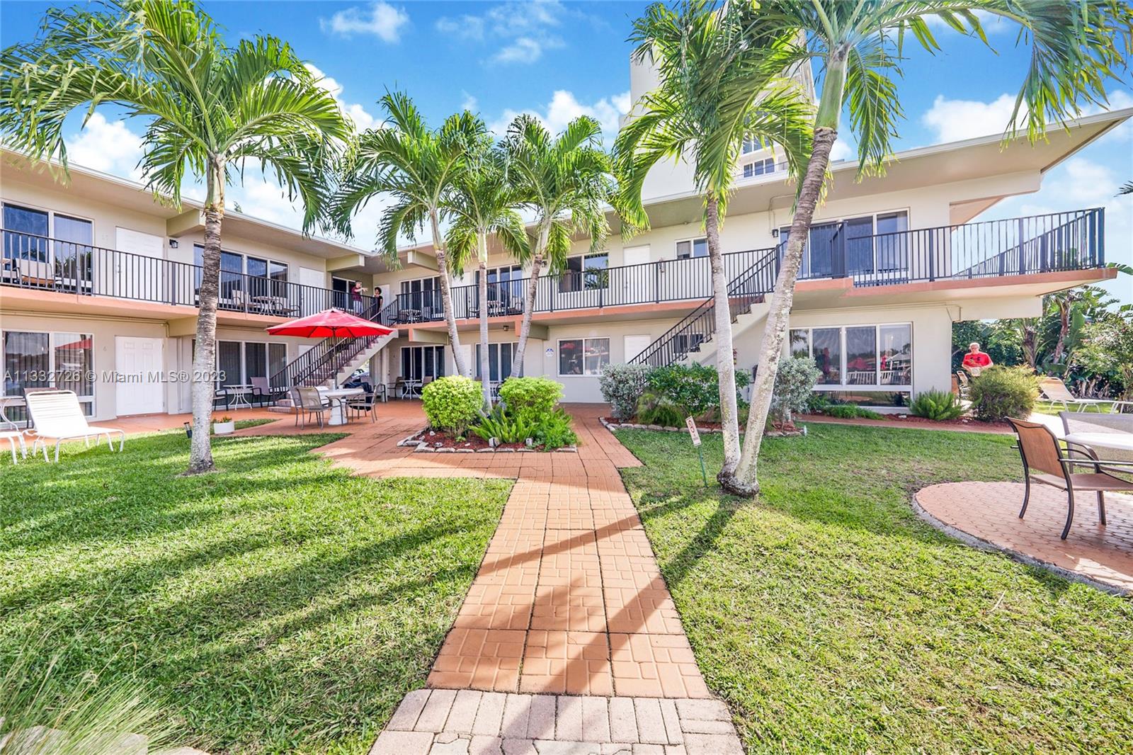 555 North Riverside Drive, Unit 15 Pompano Beach, FL 33062 - Photo 12 of 18 a front view of a building with garden