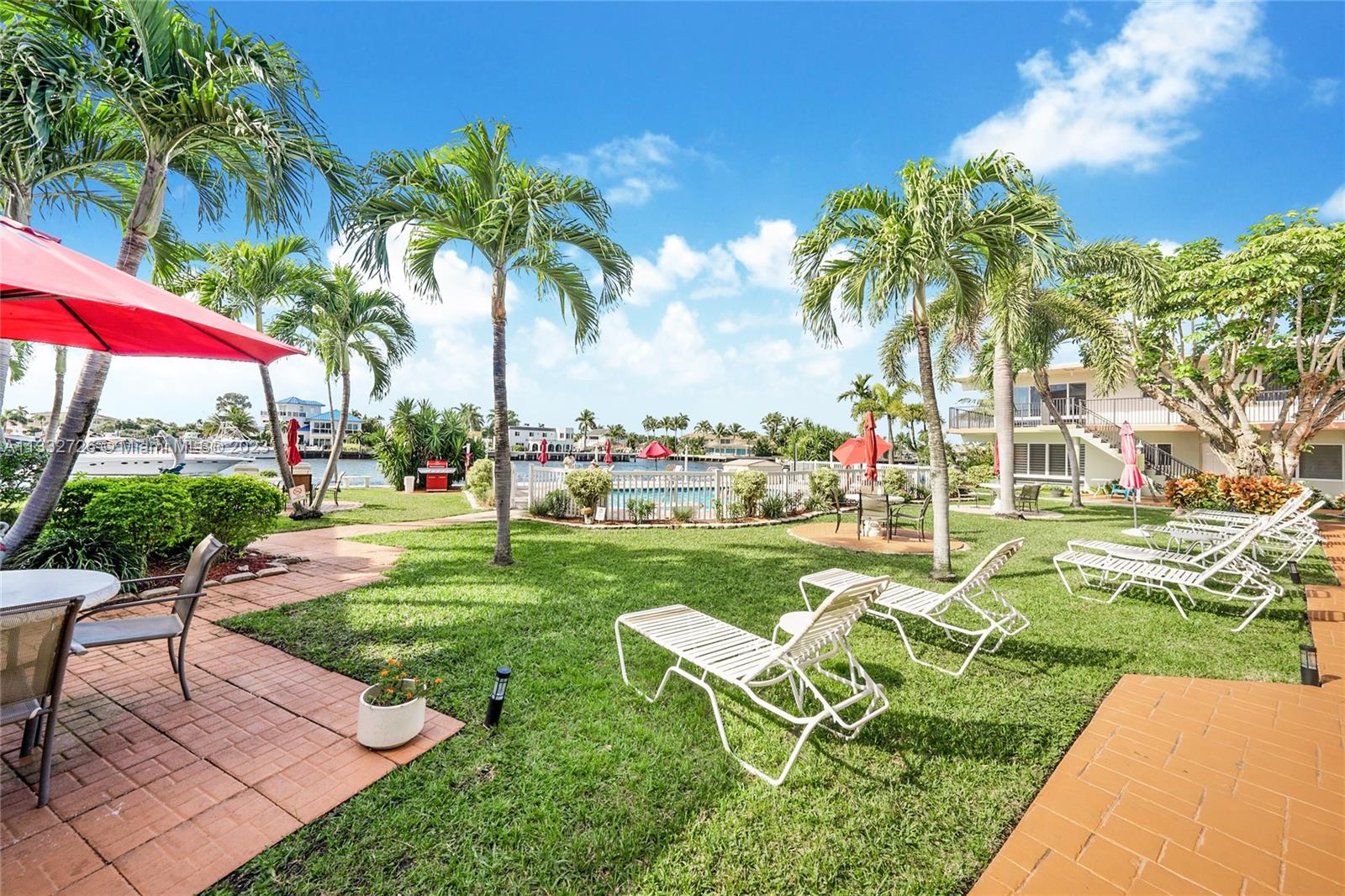 555 North Riverside Drive, Unit 15 Pompano Beach, FL 33062 - Photo 13 of 18 a view of a table and chairs in patio with a garden