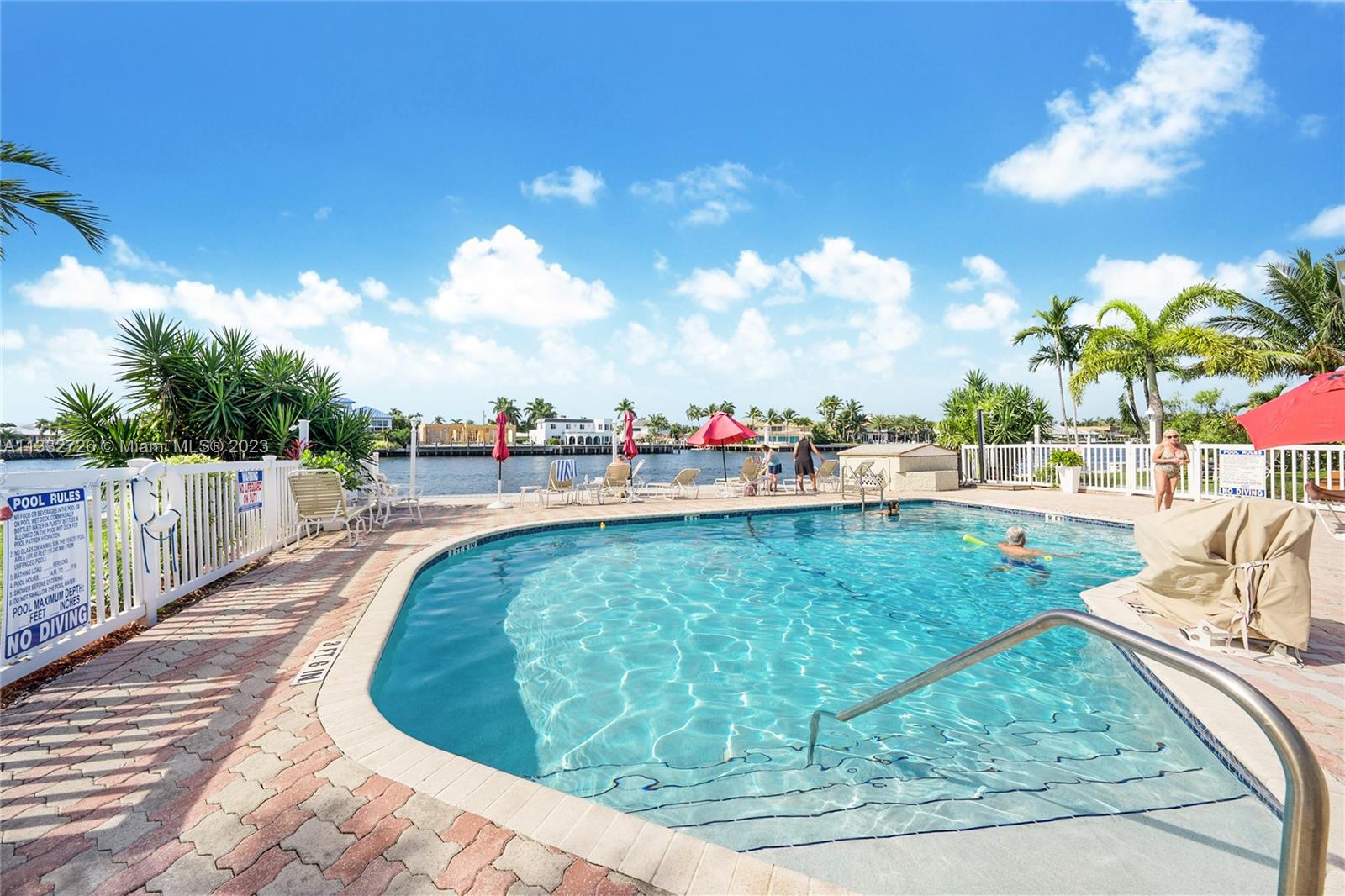 555 North Riverside Drive, Unit 15 Pompano Beach, FL 33062 - Photo 2 of 18 a view of a swimming pool with a yard