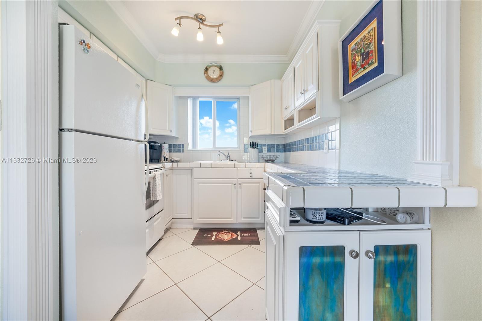 555 North Riverside Drive, Unit 15 Pompano Beach, FL 33062 - Photo 6 of 18 a kitchen with stainless steel appliances a refrigerator sink and cabinets
