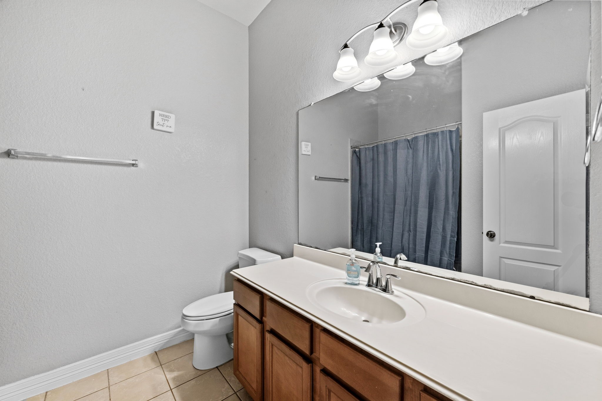 1405 Big Hill Road Winnie, TX 77665 - Photo 30 of 43 a bathroom with a sink a toilet and a large mirror