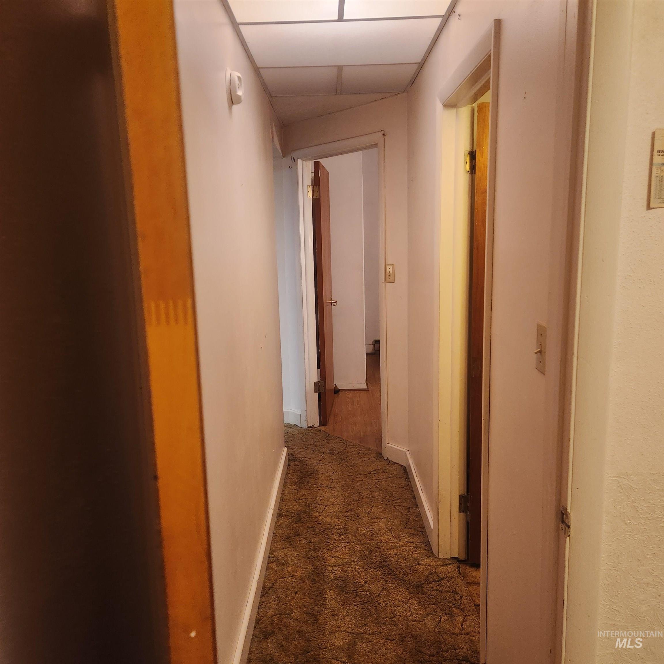 530 California Street Gooding, ID 83330 - Photo 15 of 30 Corridor featuring dark colored carpet and a drop ceiling