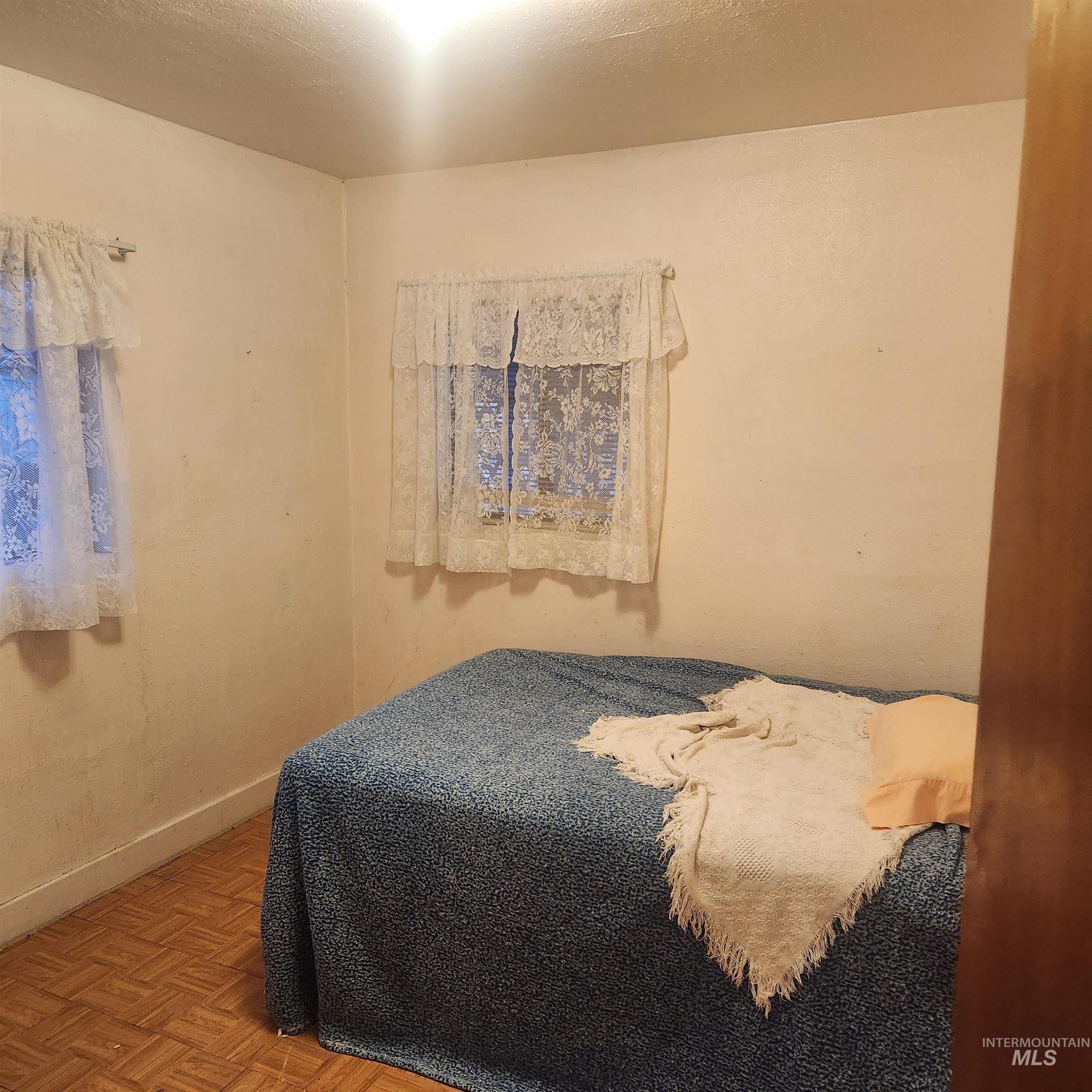 530 California Street Gooding, ID 83330 - Photo 18 of 30 Bedroom featuring parquet floors and baseboards