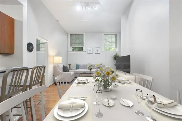 a dining room with furniture and wooden floor