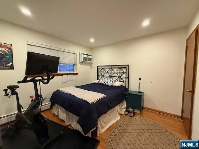 a bedroom with furniture and a flat screen tv
