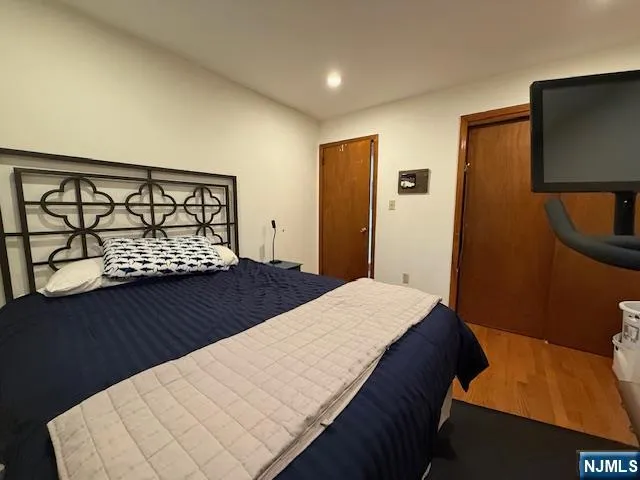 a bedroom with a bed and a dresser