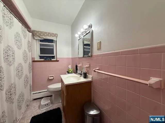 a bathroom with a sink a toilet a mirror and shower