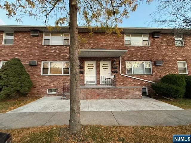 front view of a brick house with a yard