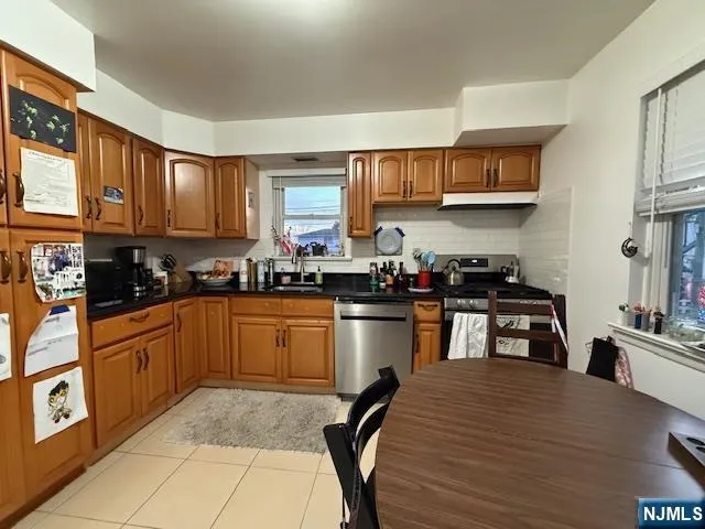 a kitchen with stainless steel appliances granite countertop a refrigerator sink and cabinets