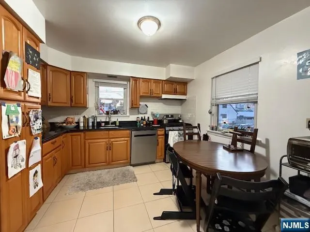 a kitchen with granite countertop a sink counter and chairs