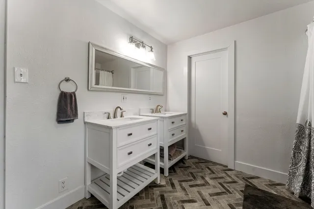 a bathroom with a sink toilet and mirror