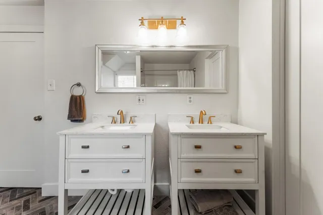 a bathroom with a double vanity sink and mirror