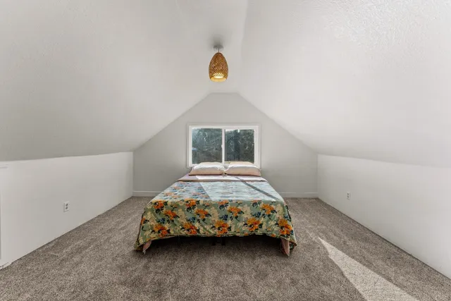 a bedroom with a bed and window