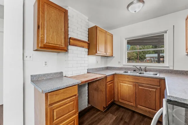 a kitchen with stainless steel appliances granite countertop a sink stove and cabinets