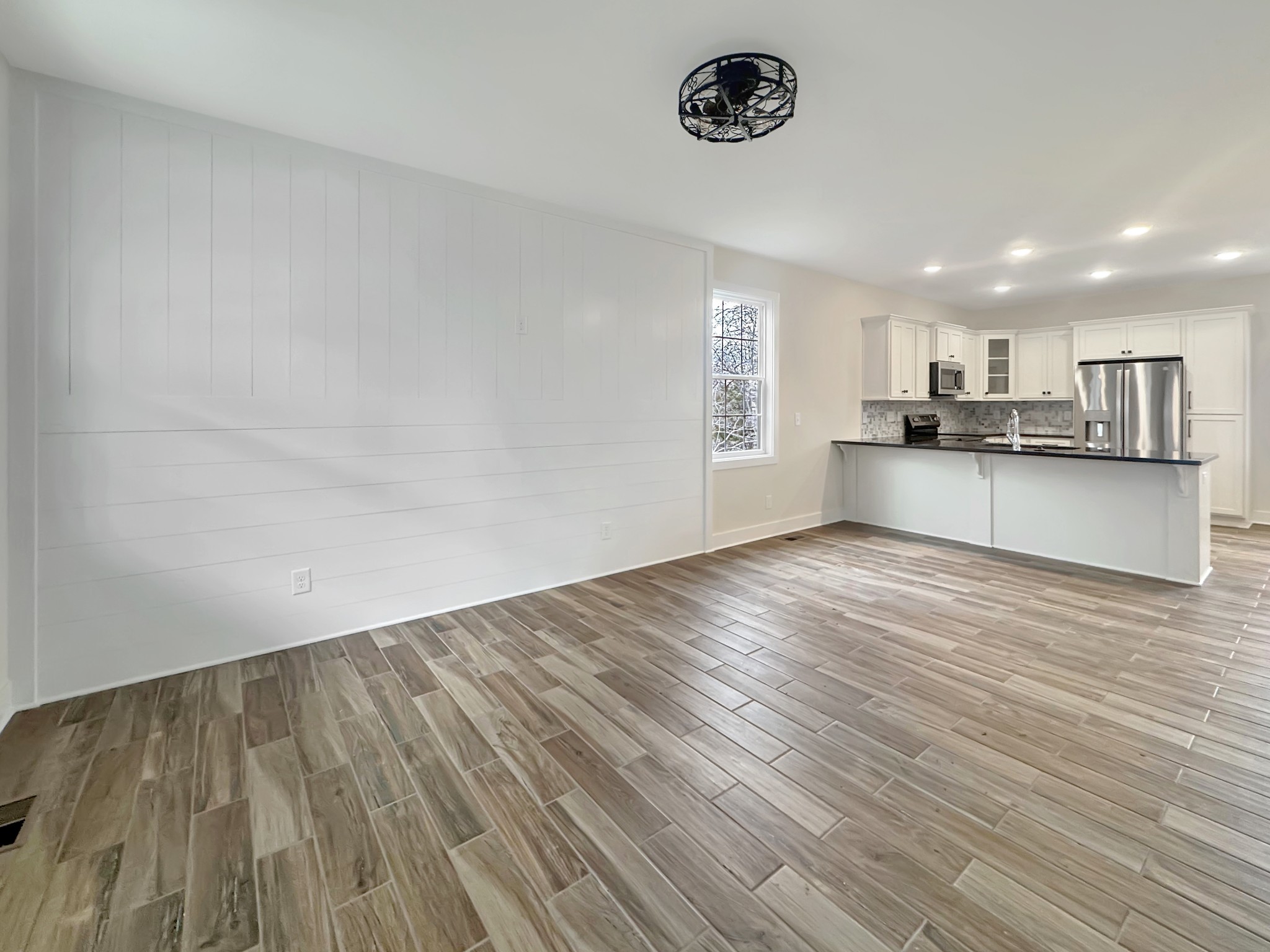 200 Hood Street Dover, TN 37058 - Photo 2 of 27 an empty room with a wooden floor and windows
