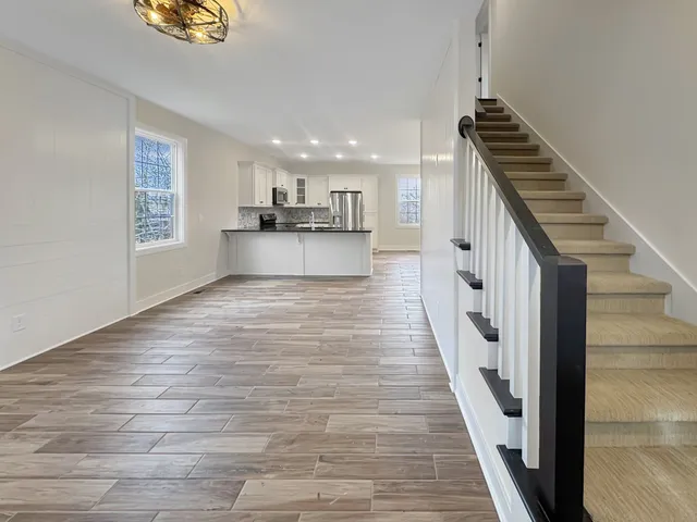 a view of kitchen and hall with wooden floor