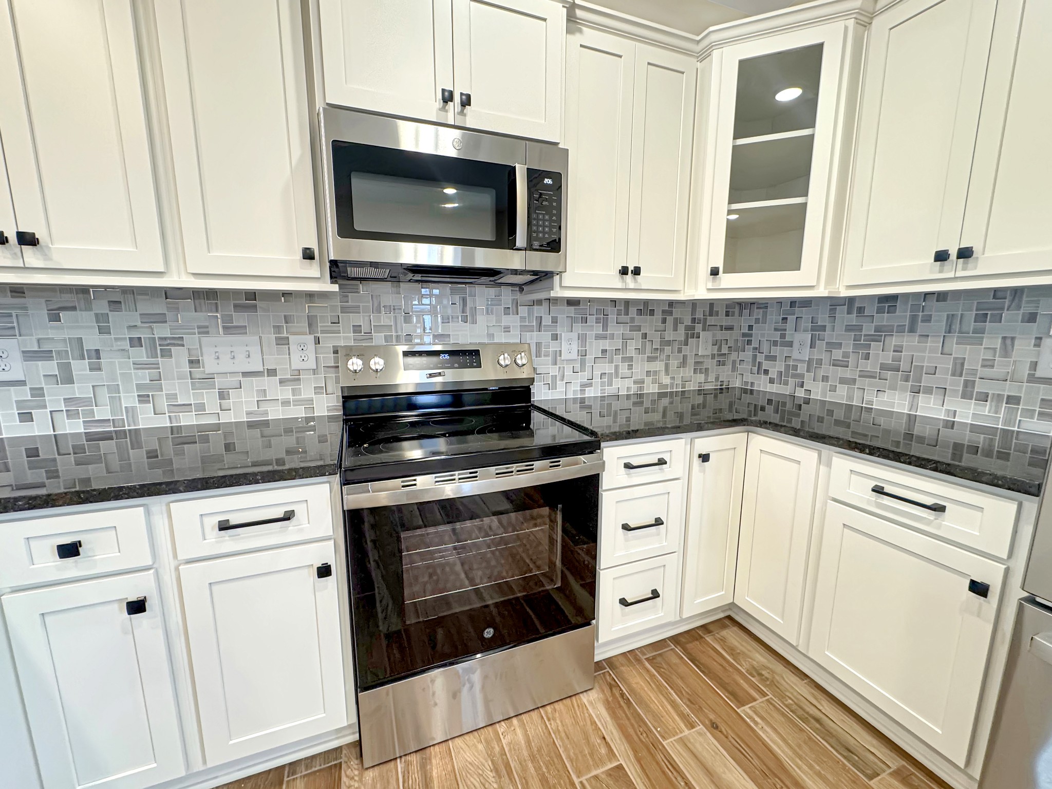 200 Hood Street Dover, TN 37058 - Photo 4 of 27 a kitchen with white cabinets stainless steel appliances and sink
