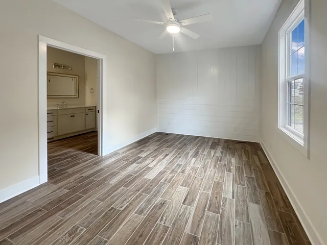 wooden floor in an empty room with a window