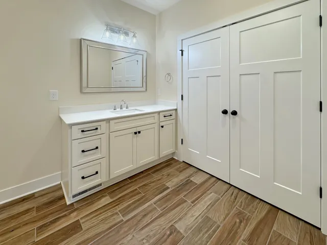 a bathroom with a sink a mirror and a vanity