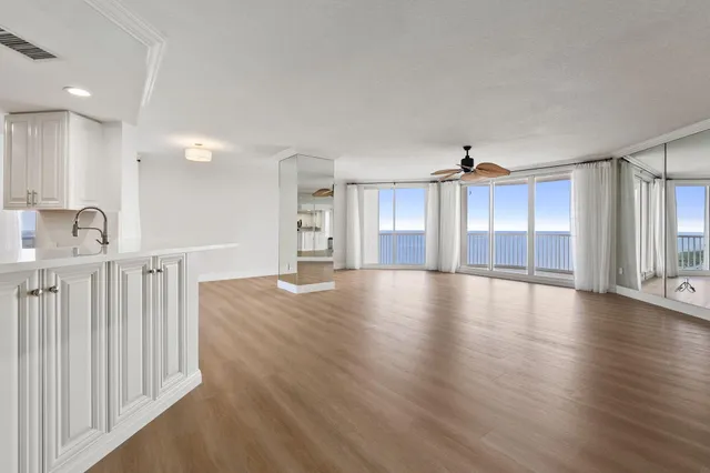 a kitchen with a sink cabinets and wooden floor