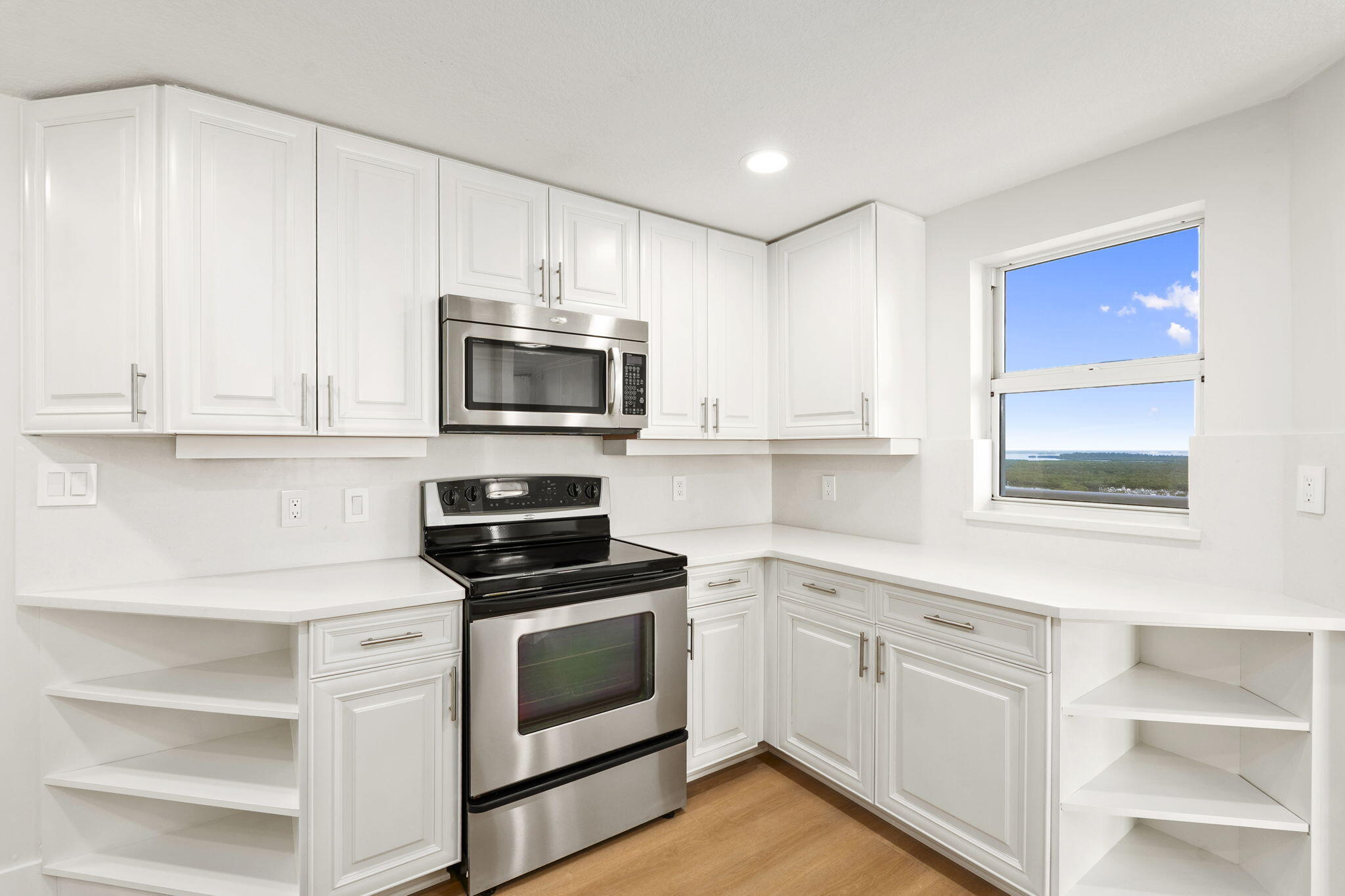 5051 North Hwy A1A, Unit PH24 Fort Pierce, FL 34949 - Photo 15 of 50 a kitchen with white cabinets stainless steel appliances and sink
